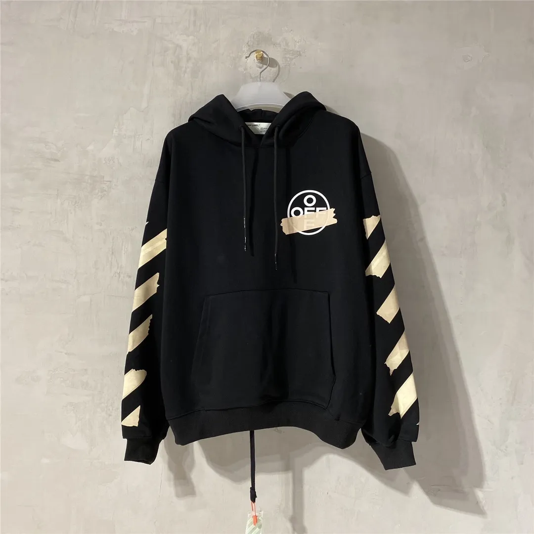 Spring and autumn top tested version OFF WHITE OW hot stamping strip printing male and female couples pure cotton loose same style pullover hooded sweatshirt The printing is done on a Japanese-owned Mimaki printing machine, with no edges or burrs. Inkjet heat transfer is hot-pressed and cold-teared, and the high temperature is 180 degrees. The front piece needs to be pressed twice (the second time requires 180kg of air pressure). The transparent fabric is anti-scratch and ironing, and the printing is fog-free. The semi-transparent tape in the front circle can reveal the part of the printing underneath. The golden printing color of the tape is not The flat color and tape printing overlap have different color depths. The wash label is also customized according to the original font. The accessories still use the full line of correct accessories. The rectangular woven collar label design is cancelled. The previous three-dimensional silicone feel font is changed to a fully woven collar label. Fluorescent fonts can be seen on the collar label. The five-link silicone hangtag, three-link washable label and zebra crossing packaging line are still the same. 480g pure cotton terry fabric, a major launch with full drape. A full set of customized accessories, one-to-one mold opening, professional ow. Size: XS-L Size chart